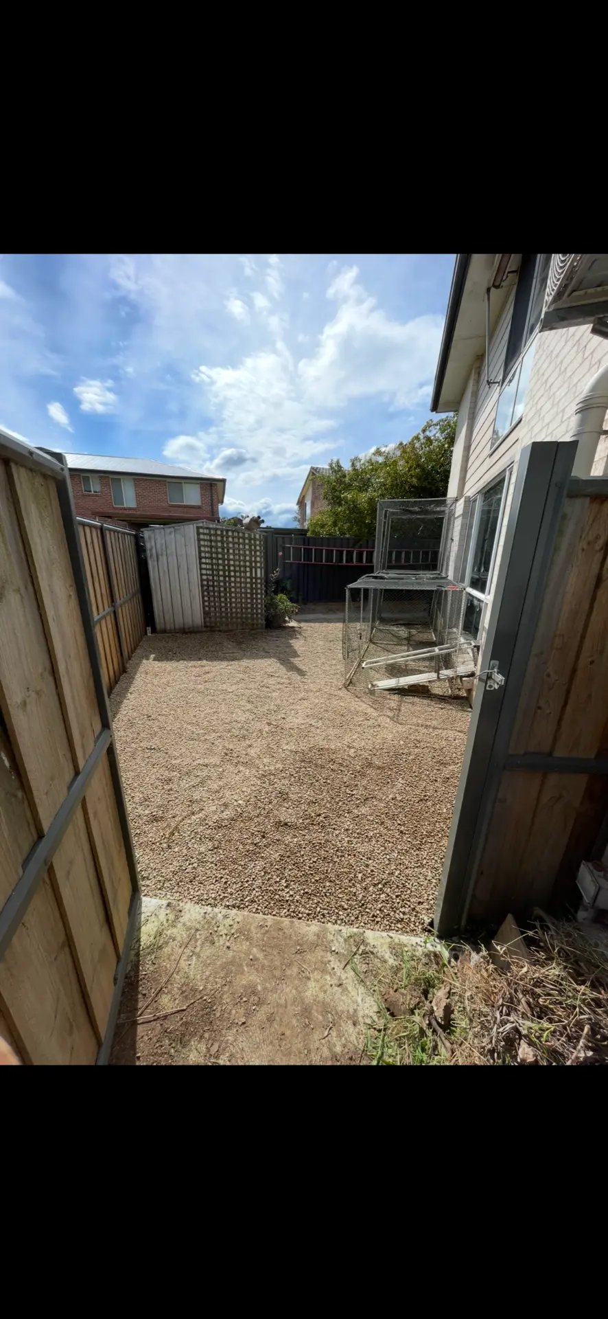 The same side yard cleared and finished with a neat gravel surface